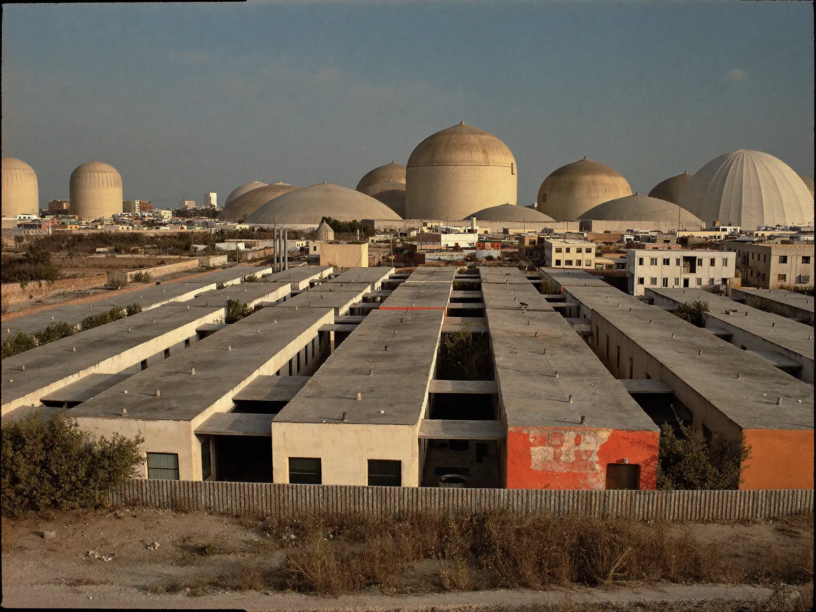 Low-rise villas and warehouses in Al Quoz with water tanks on flat concrete roofs